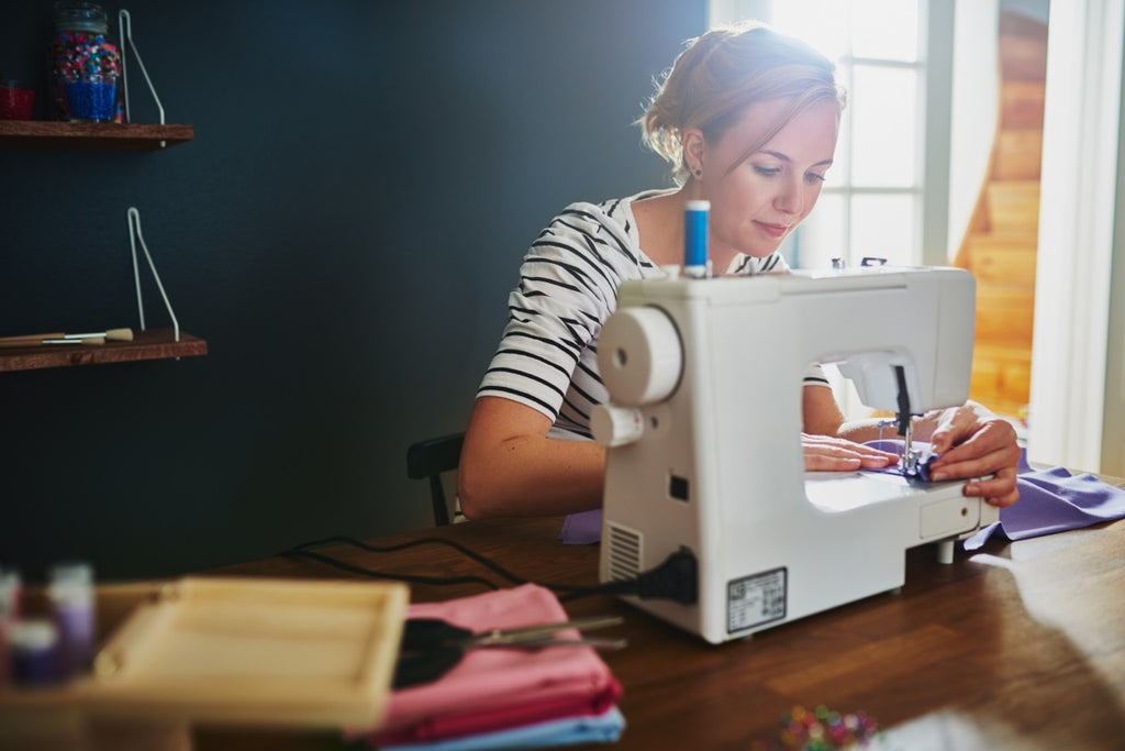 Woman Sewing On Sewing Machine