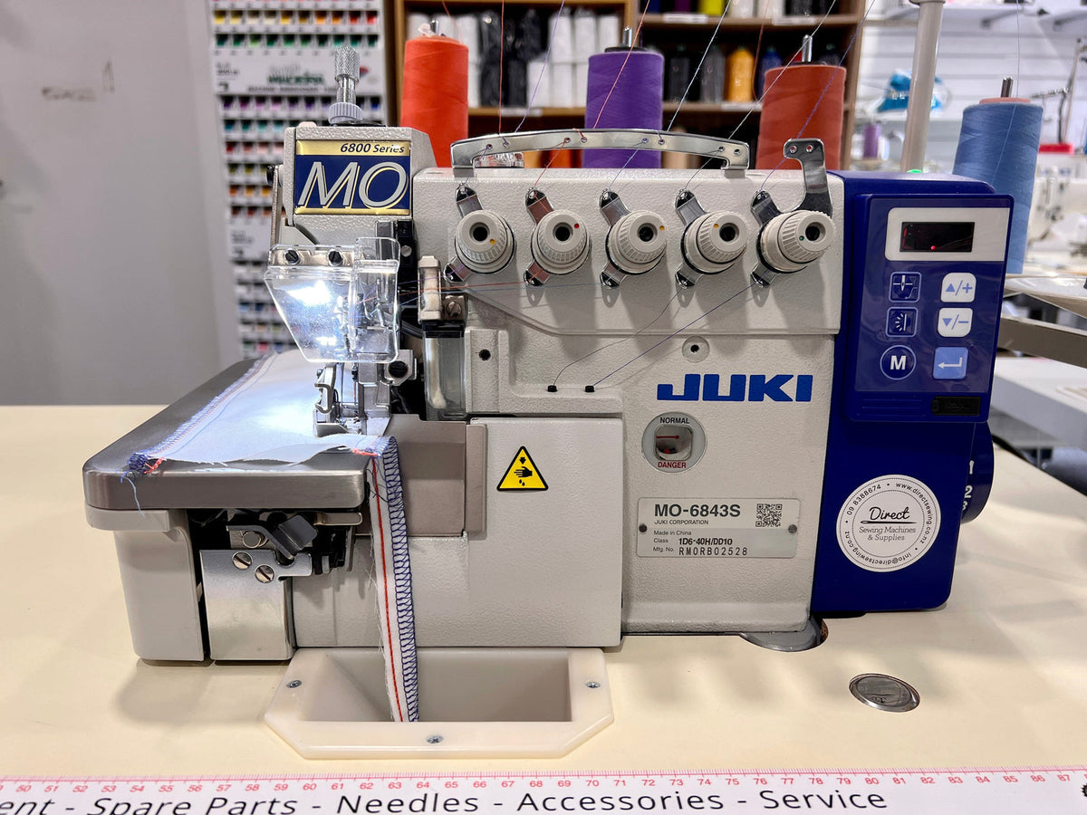 JUKI MO-6843S six-thread industrial safety stitch overlocker on sewing table