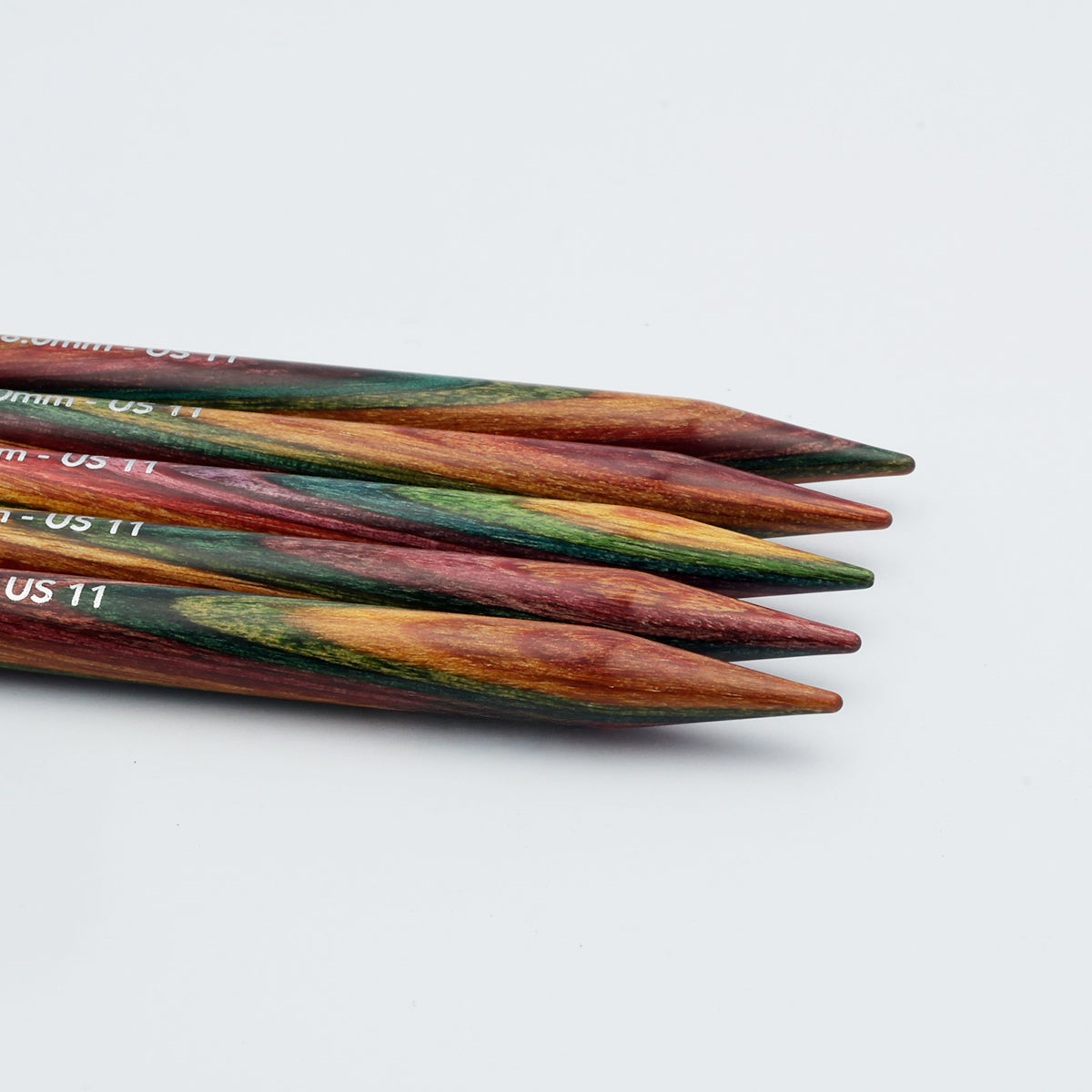 Side view of KnitPro Symfonie 2 double pointed needles showing rainbow laminated wood