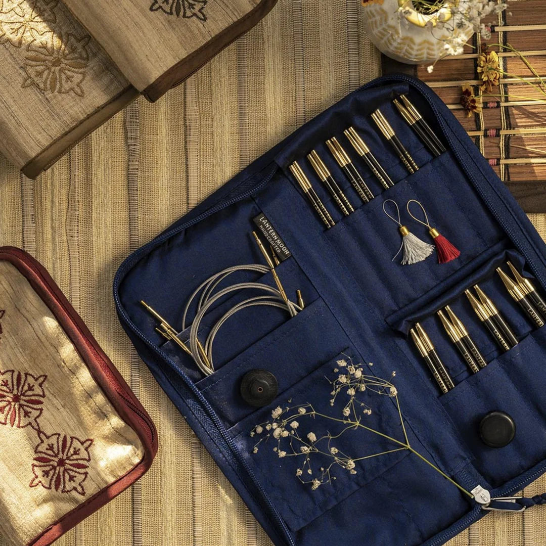 Lantern Moon Heirloom ebony interchangeable tips and cables arranged in an open navy Khadi silk case