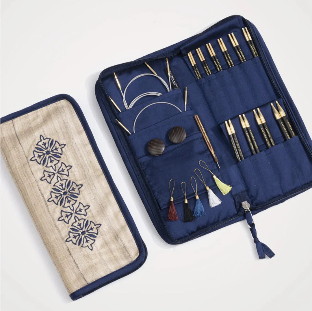 Open Lantern Moon Heirloom 13cm interchangeable needle set with ebony tips, cables and accessories beside embroidered Khadi silk case