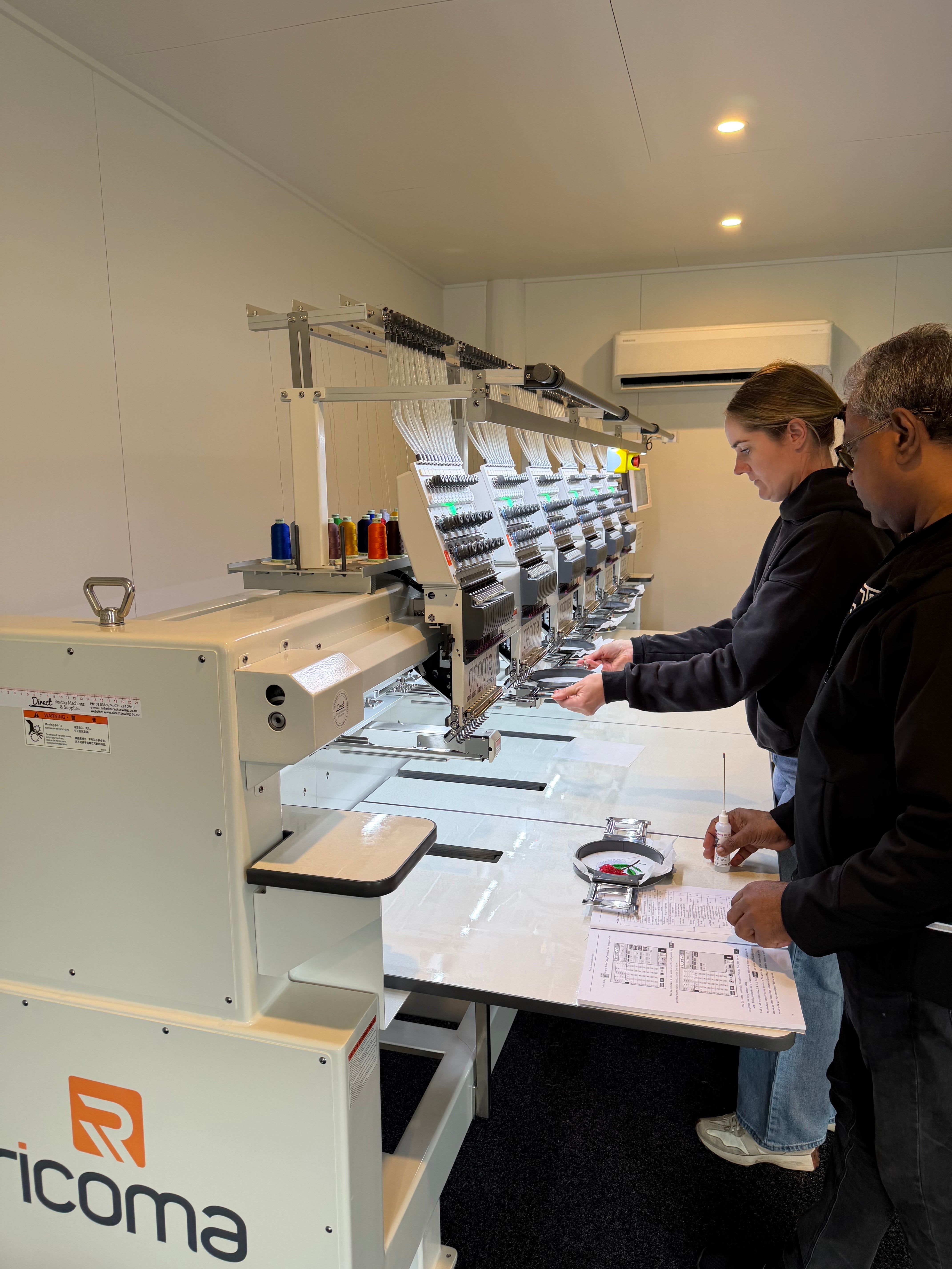 Nicole receiving hands-on training on Naninama Embroidery's new Ricoma machine