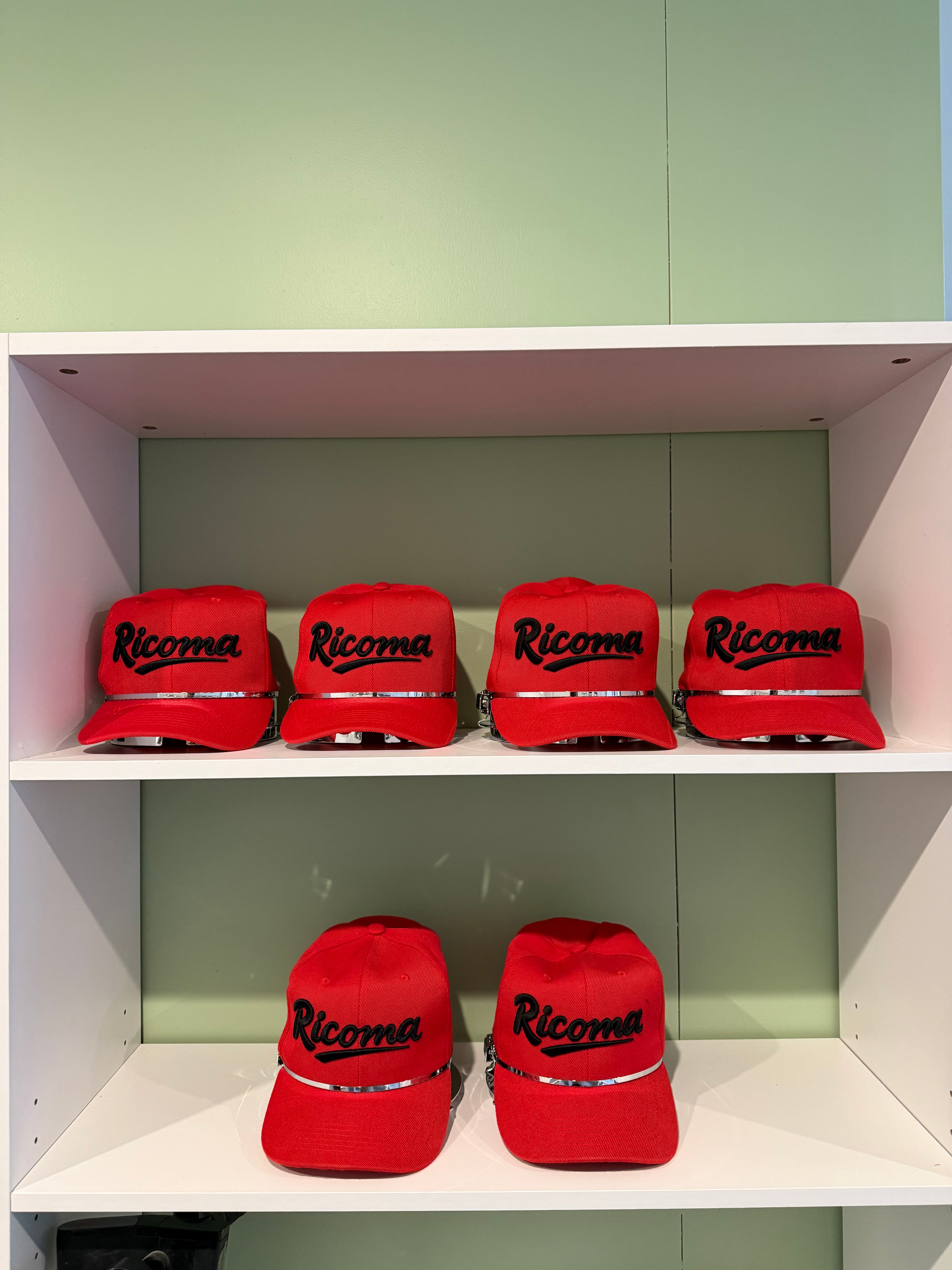 Red caps embroidered with the Ricoma logo during the Alexandra installation