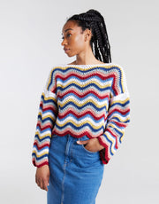 Wool and the Gang Malibu Sweater crochet pattern, model wearing the multicoloured wavy-stripe design
