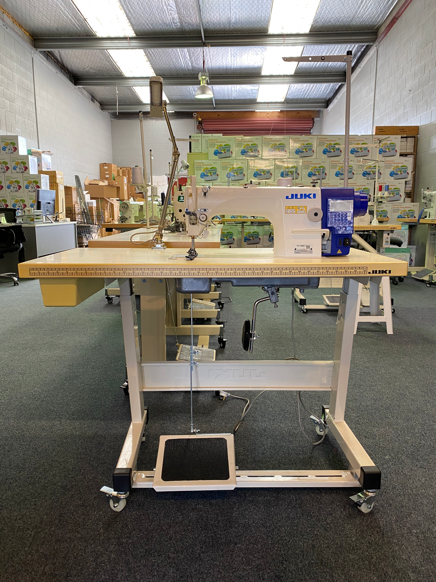 Complete JUKI DDL-7000AS-7 industrial workstation with table stand treadle and wheels