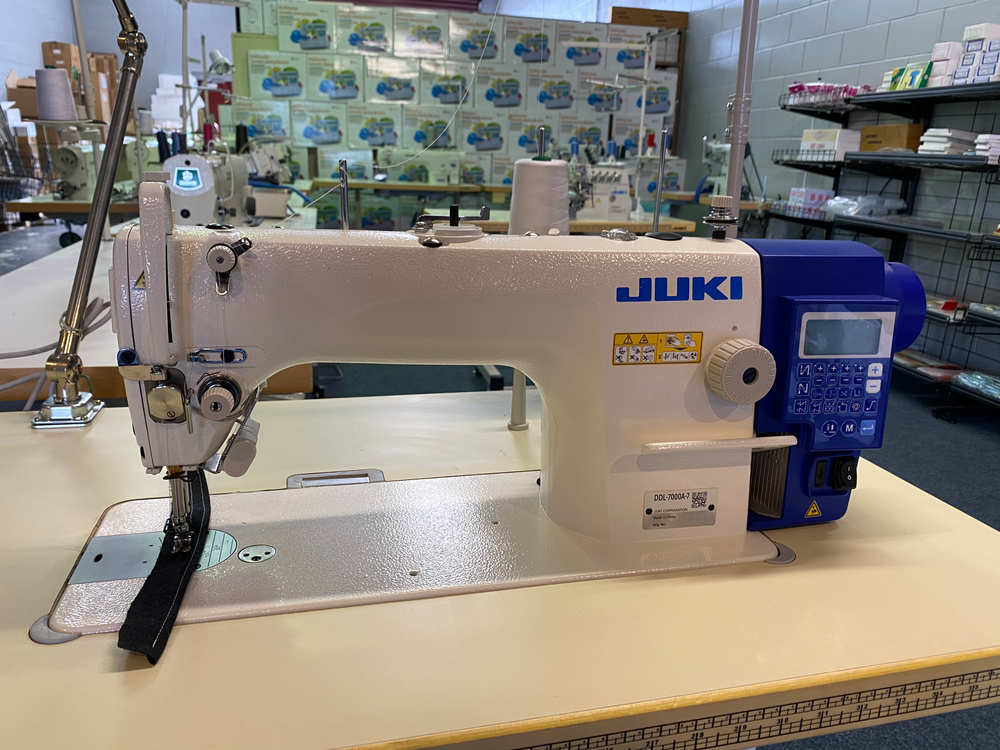 Front view of the JUKI DDL-7000AS-7 control panel and sewing head
